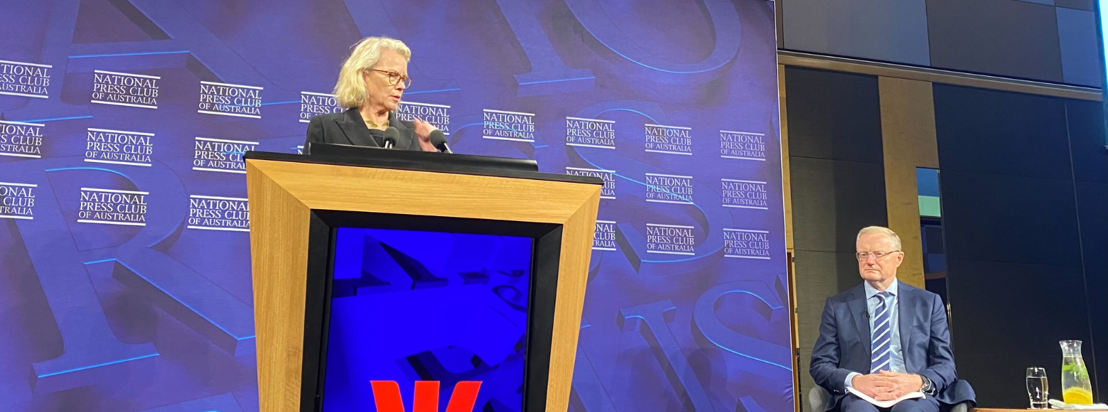 RBA Governor Phil Lowe on stage alongside ABC 7:30 Chief Political Correspondent/National Press Club President Laura Tingle